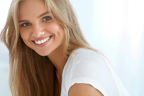 Woman wearing Invisalign clear aligners in Bellevue NE