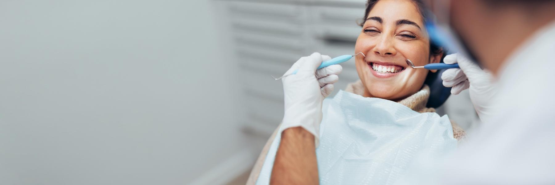 Woman smiling at oral surgeon in Bellevue NE