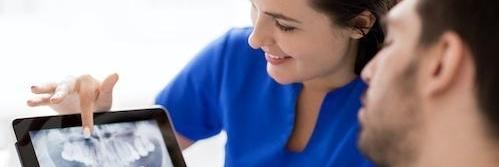 Dentist near me showing patient a digital x-ray scan in Bellevue