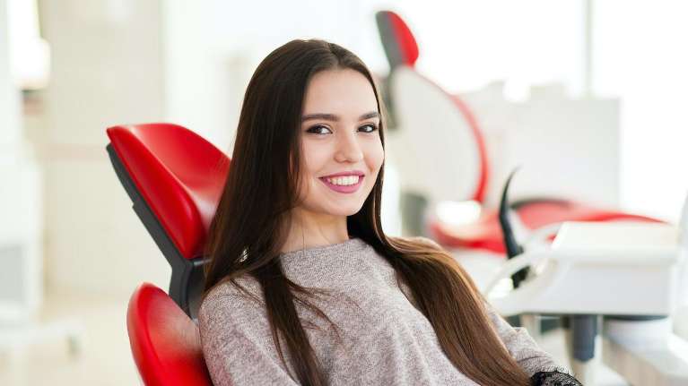 A woman in a dental chair receives focused care for advanced periodontal disease.