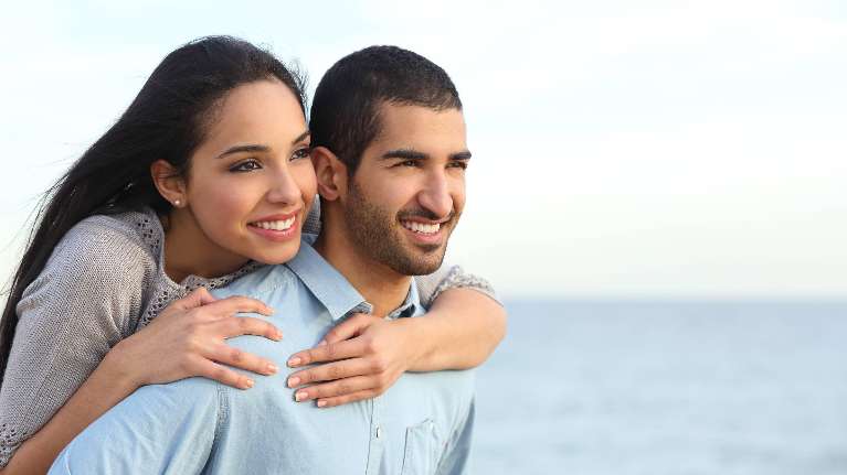 A man carrying a woman