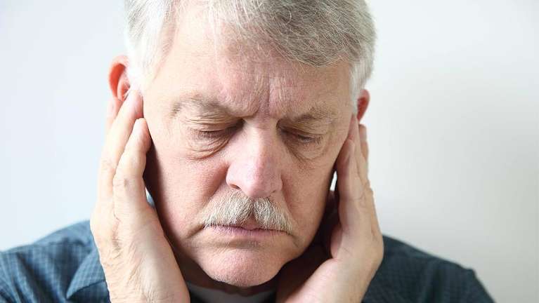 A man covering his ears with his hands