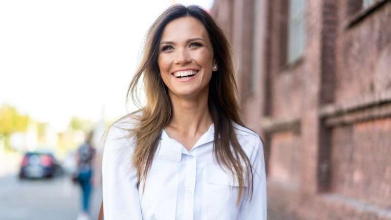 Woman in Bellevue NE smiling with her full set of teeth