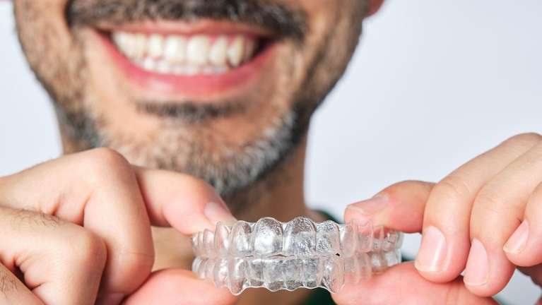 Man in Bellevue holding Invisalign