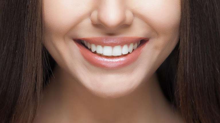 Girl smiling with her gum disease free teeth in Belleuvue NE