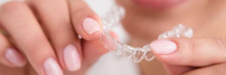 A lady holds Invisalign in Bellevue