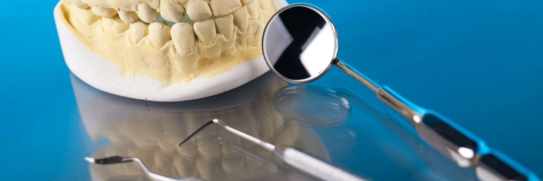 Molded teeth and dental materials on a glass table in Belleuve NE